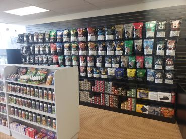Wide view of the Lit Tobacco showroom with fully stocked aisles