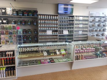 Vape display shelves stocked with a wide selection of e-liquids and devices