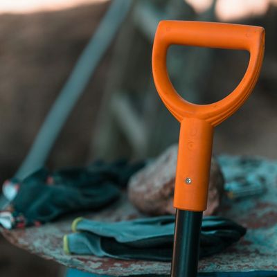 orange handle of a shovel