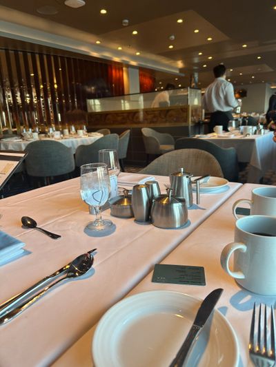 Elegant restaurant table setting with white tablecloth and silverware.