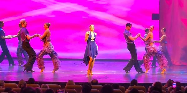 Ballroom dancers perform in the Ballroom Fever show on the stage of Navigator of the Seas