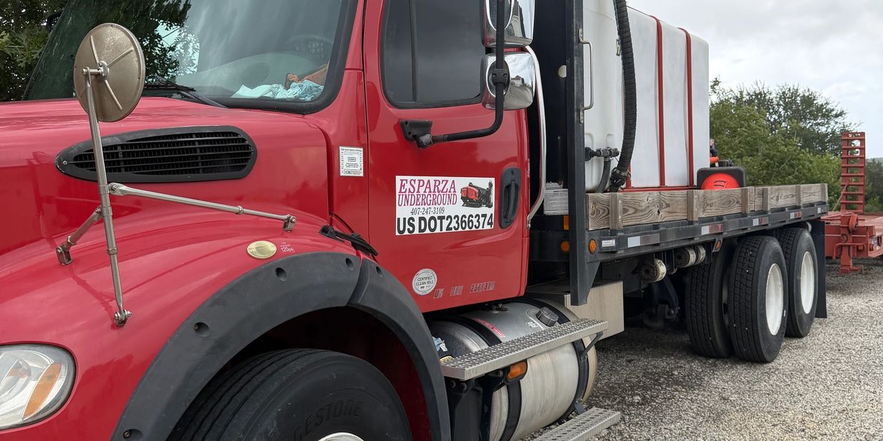 Red cargo truck with Esparza Underground sign.