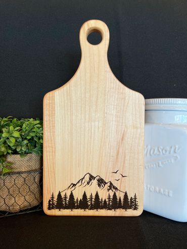 Cutting board with a mountain scene