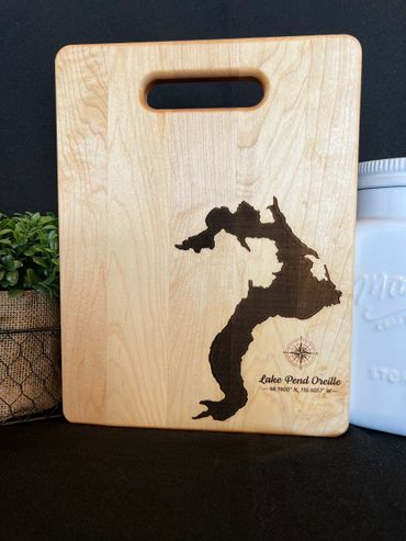 Maple cutting board with lake Pend Oreille and a compass