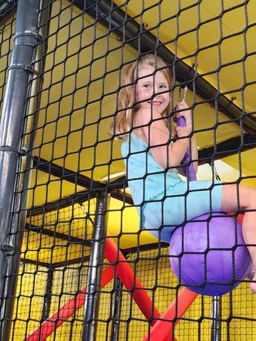 Girl playing in play structure at Poppets Play Place Indoor playground West Knoxville Farragut