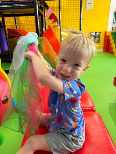 Toddler playing with scarves at Poppets Play Place Indoor playground West Knoxville Farragut