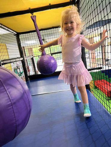 Toddler playing in the play structure at Poppets Indoor playground West Knoxville Farragut