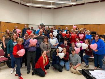 The group holding heart balloons