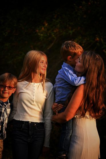 Between giggles and golden light, she paused - just long enough to see love blooming in her baby bro