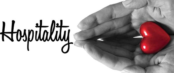 Hands holding a red heart with the word Hospitality.