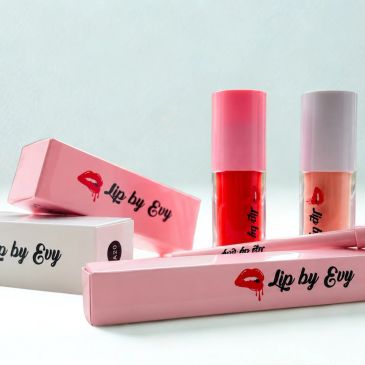 Lip by Evy branded lip gloss and packaging in pink and red colors.
