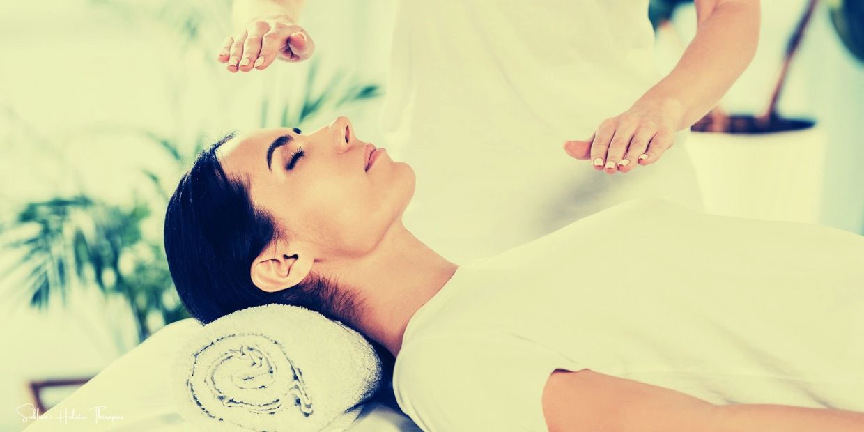 A woman receiving Reiki healing