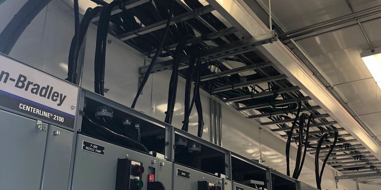 Electrical control panel with cables overhead.