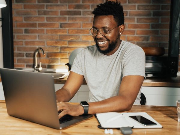 African male working from his laptop