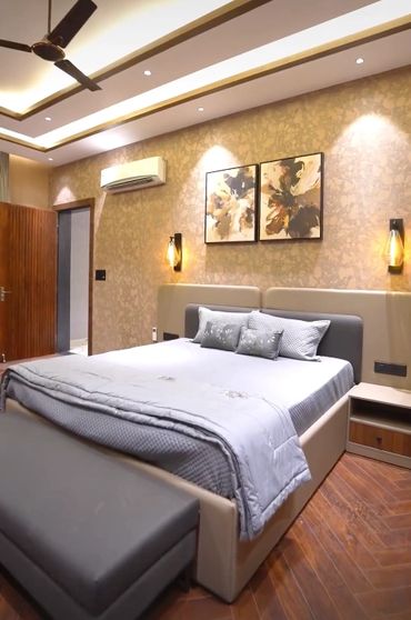 Modern bedroom with elegant decor and soft lighting.
