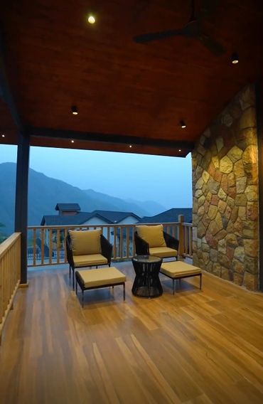 Cozy outdoor seating area with mountain view under a wooden roof in a 3BHK mansion at Chalang, Dehradun