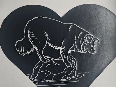 White t-shirt with a black heart and a dog standing on a rock design.