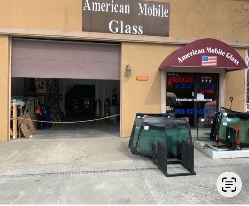 Exterior view of American Mobile Glass with car windshields outside.