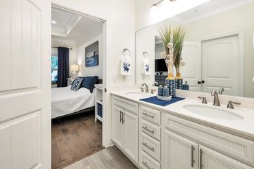 Master bathroom with double vanity, walk-in closet and walk-in shower.