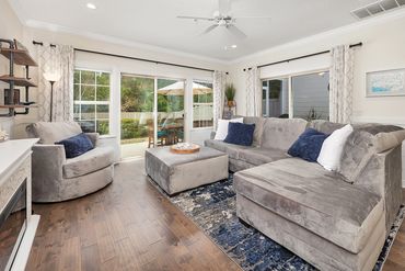 Living room overlooking the back yard and screen room. Super comfortable couches!