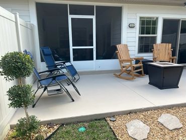 Patio with lounge chairs and Adirondack chairs (no more rockers) and gas firepit.