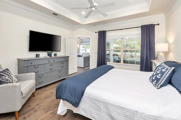 Master bedroom with 50" smart tv, overlooking the screen room and back yard!