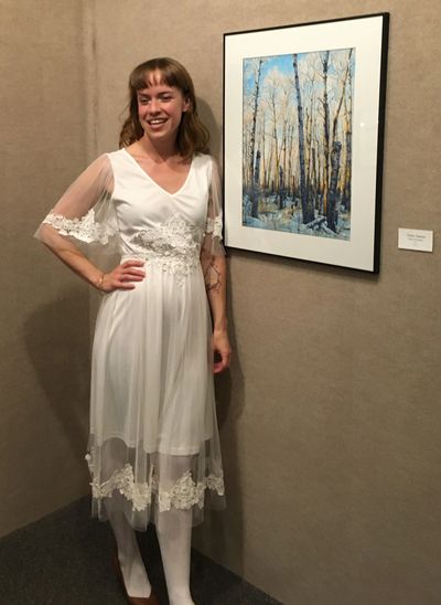 Justine Bouchard on opening night of the 'Peace Roots' exhibition standing by the original piece 'Poplar Opinion' 