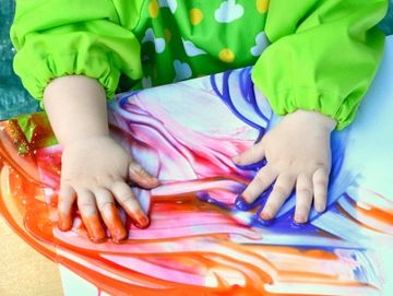 Small girl finger painting