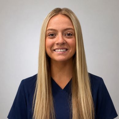 Young woman with straight blonde hair smiling.