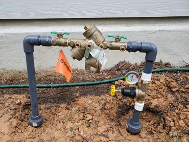 Backflow Device. Sut-off Valves to right and left of the Backlfow-(center brass pipe)