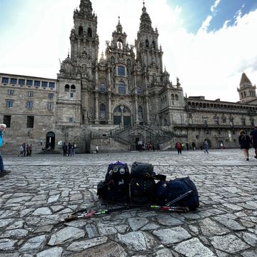 3 backpacks in front of the Santiago de Compostela Cathedral. The end out the Camino journey, Spain.