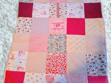 Colorful patchwork quilt with various patterns and images.