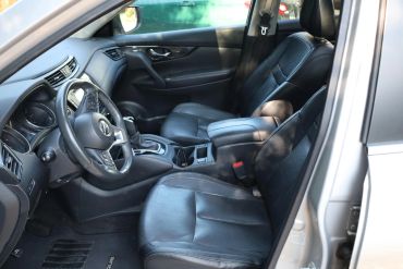 Interior view of a car with black leather seats and steering wheel.