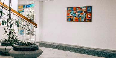 Art gallery with colorful abstract art work on the wall 