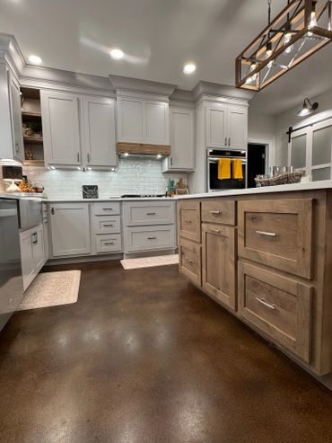 Modern kitchen with white cabinets and wooden island.