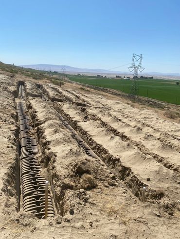 INFILTRATOR CHAMBERS INSTALLED ON SEPTIC SYSTEM TRENCHES FOR FARM HOUSING PROJECT. PASCO, WA