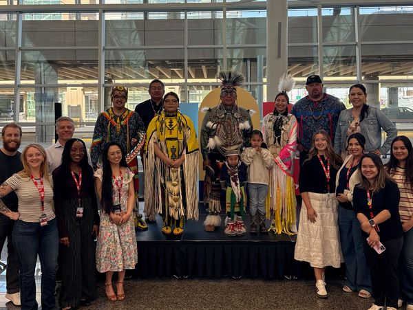 Group photo with people in traditional Native American attire.