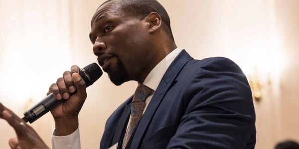 Khalid Bey speaking at an event in Albany, NY.