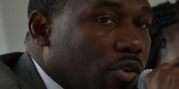 Khalid Bey speaking on a panel about gun violence.