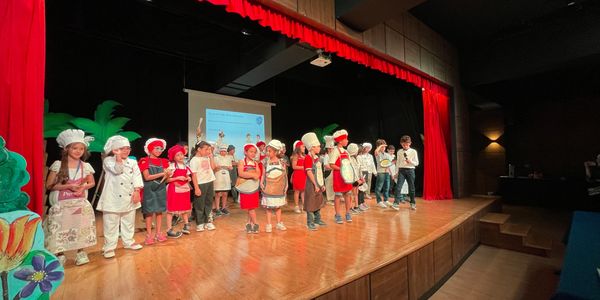 KG boys and girls in school theater