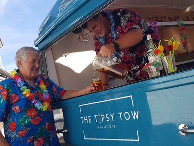 Man serving drink from a mobile bar
