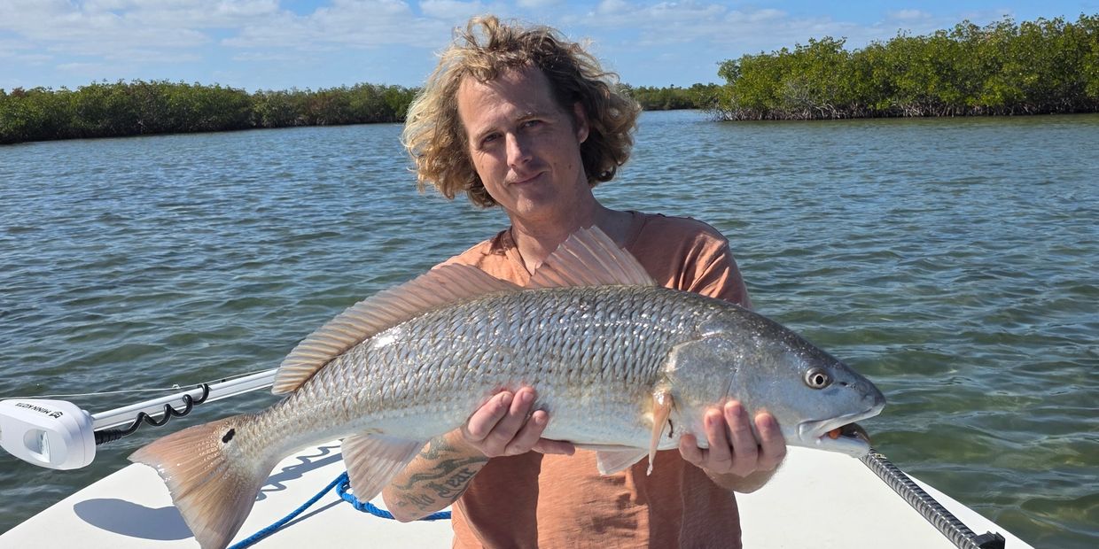My son with a nice redfish caught inshore fishing Daytona Beach