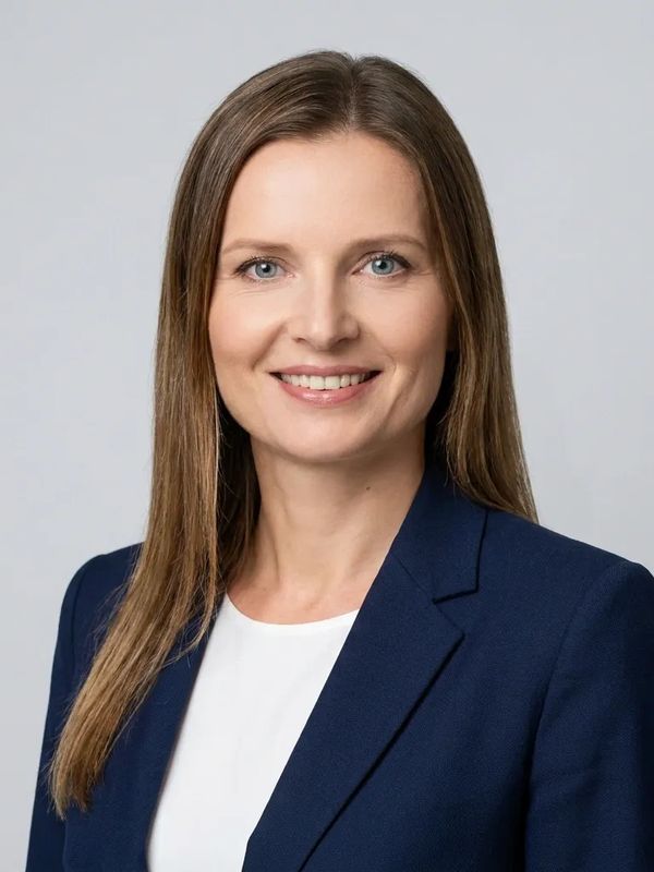Professional woman in blue blazer smiling.
