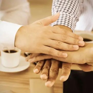 Stacked hands symbolizing founder trust succession planning and long-term partnership