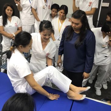 Nurses practicing patient care techniques.