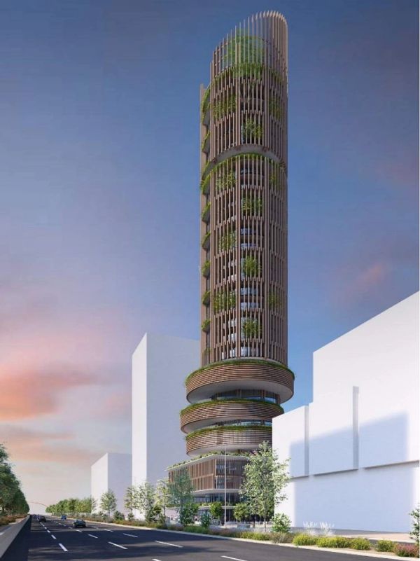 A tall, modern cylindrical building with greenery on balconies.