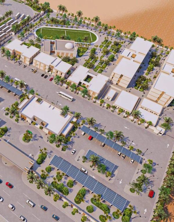 Aerial view of a modern school campus with sports facilities and solar panel parking.