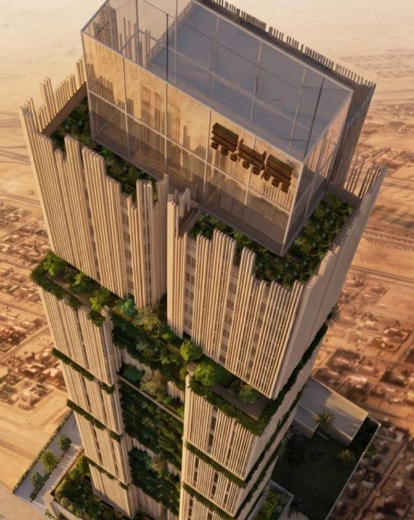 Tall modern skyscraper with vertical lines and greenery.