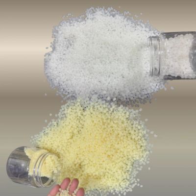 Two jars spilling white and yellow granules.