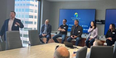 Panel discussion in a modern conference room with a presenter and attentive audience.